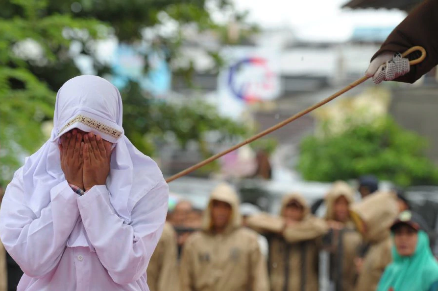 New Straits Times This picture depicts a Muslim women being caned in Acheh, Indonesia, where public caning has been implemented for nearly 20 years.